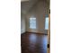 Well-lit bedroom featuring two windows and laminate flooring at 416 Culloden Moor Dr, Mcdonough, GA 30253