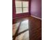 Charming bedroom with pink and purple walls and wood-look flooring at 416 Culloden Moor Dr, Mcdonough, GA 30253