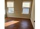 Bright bedroom with two windows and wood-look flooring at 416 Culloden Moor Dr, Mcdonough, GA 30253