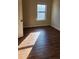 Simple bedroom with a window and laminate wood flooring at 416 Culloden Moor Dr, Mcdonough, GA 30253