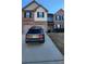 Two-story house with gray and white brick exterior, two-car garage, and driveway at 416 Culloden Moor Dr, Mcdonough, GA 30253