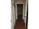 A long hallway with hardwood floors and neutral-colored walls at 416 Culloden Moor Dr, Mcdonough, GA 30253