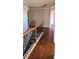 Upstairs hallway with hardwood floors and access to bedrooms at 416 Culloden Moor Dr, Mcdonough, GA 30253