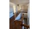 Upstairs hallway with hardwood floors and railing at 416 Culloden Moor Dr, Mcdonough, GA 30253