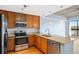 Well-lit kitchen with granite countertops, stainless steel appliances, and ample cabinet space at 563 Memorial Se Dr # 405, Atlanta, GA 30312