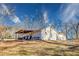 Rear exterior view of a single-story home showcasing an open yard and a covered patio area at 12524 Highway 36, Covington, GA 30014