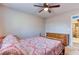 Comfortable bedroom shows patterned bedding, wood furnishings and view to doorway at 12524 Highway 36, Covington, GA 30014