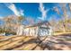 Home exterior featuring a garage and driveway, set in a green yard with mature trees at 12524 Highway 36, Covington, GA 30014