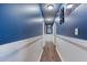 Hallway with hardwood floors and blue walls at 12524 Highway 36, Covington, GA 30014