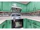 Corner kitchen with stone backsplash, smooth countertops, and black stove at 12524 Highway 36, Covington, GA 30014