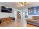 Spacious living room with wooden floors, ample seating, and a large television at 12524 Highway 36, Covington, GA 30014