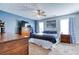 Primary bedroom features a ceiling fan, large windows, and neutral paint at 12524 Highway 36, Covington, GA 30014