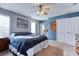 Primary bedroom features a ceiling fan, large windows, and blue accent wall at 12524 Highway 36, Covington, GA 30014