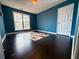 Bright bedroom with dark laminate wood flooring and teal walls at 1760 Marceau Dr, Conley, GA 30288