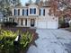 Two-story house with beige siding, black shutters, and a two-car garage at 1760 Marceau Dr, Conley, GA 30288