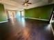Spacious main bedroom with dark hardwood floors and a green accent wall at 1760 Marceau Dr, Conley, GA 30288