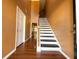Grand staircase with dark wood treads and white risers at 1760 Marceau Dr, Conley, GA 30288