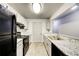 Modern kitchen with black appliances and granite countertops at 3102 Fairington Village Dr, Lithonia, GA 30038