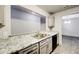 Kitchen boasts granite countertops, gray cabinets, and a view to dining area at 3102 Fairington Village Dr, Lithonia, GA 30038