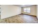 Empty living room with wood-look floors and large window at 3102 Fairington Village Dr, Lithonia, GA 30038