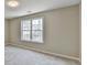 Simple bedroom with carpeted floor and a window at 591 Paper Ridge Ct, Lawrenceville, GA 30046