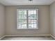 Well-lit bedroom with a large window offering a view of the neighborhood at 591 Paper Ridge Ct, Lawrenceville, GA 30046