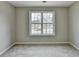 Bright bedroom with neutral walls and carpet at 591 Paper Ridge Ct, Lawrenceville, GA 30046