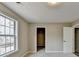 Bright bedroom with a large window, closet, and neutral color palette at 591 Paper Ridge Ct, Lawrenceville, GA 30046