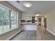 Modern kitchen with white cabinets, breakfast bar, and vinyl flooring at 591 Paper Ridge Ct, Lawrenceville, GA 30046