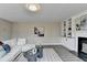 Bright living room featuring a fireplace and built-in shelving at 591 Paper Ridge Ct, Lawrenceville, GA 30046