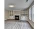 Living room featuring built-in shelving, fireplace, and luxury vinyl plank flooring at 591 Paper Ridge Ct, Lawrenceville, GA 30046