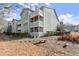 Multi-level condo building featuring private balconies and mature landscaping at 2042 Brian Way, Decatur, GA 30033