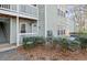 Exterior view of the condo building with well-maintained landscaping at 2042 Brian Way, Decatur, GA 30033