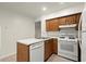 Galley kitchen featuring a white dishwasher and stove/oven and wooden cabinets at 2042 Brian Way, Decatur, GA 30033