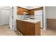 Compact kitchen features wood cabinets, white appliances, island, and tile flooring at 2042 Brian Way, Decatur, GA 30033