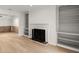 Spacious living room with a fireplace, built-in bookshelves, and light hardwood flooring at 2042 Brian Way, Decatur, GA 30033
