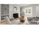 Bright living room with fireplace, built-in bookshelves, and neutral decor offers a cozy and inviting atmosphere at 2042 Brian Way, Decatur, GA 30033