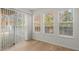 Bright room with a sliding door and multiple windows, offering ample natural light and hardwood flooring at 2042 Brian Way, Decatur, GA 30033