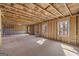 Unfinished basement with exposed framing and windows at 2210 Cormac St, East Point, GA 30344