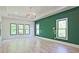 Spacious bedroom with hardwood floors, multiple windows, and an accent wall at 2346 East Maddox Rd, Buford, GA 30518