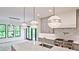 Modern kitchen with white quartz countertops and globe lighting at 2346 East Maddox Rd, Buford, GA 30518