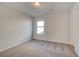 Simple bedroom with carpet flooring and a window with a view at 277 Tulip Dr, Covington, GA 30016