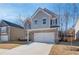 Two-story home with brick and gray siding, two-car garage, and a partially visible yard at 277 Tulip Dr, Covington, GA 30016