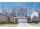 Two-story brick and gray siding home with a white two-car garage and landscaping at 277 Tulip Dr, Covington, GA 30016