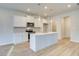 Modern kitchen with white cabinets, large island, and stainless steel appliances at 277 Tulip Dr, Covington, GA 30016