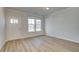 Spacious living room with large windows, light gray walls, and wood-look floors at 277 Tulip Dr, Covington, GA 30016