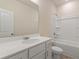 Clean bathroom with single vanity, tub, and shower at 6996 Fringe Flower Dr # 84, Austell, GA 30168