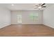 Bright living room with hardwood floors, ceiling fan, and access to a deck at 6996 Fringe Flower Dr # 84, Austell, GA 30168