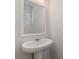 Modern powder room with white pedestal sink and mirror at 6996 Fringe Flower Dr # 84, Austell, GA 30168