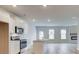 Modern kitchen with white cabinets, island, and stainless steel appliances at 75 Barge Ln, Covington, GA 30016